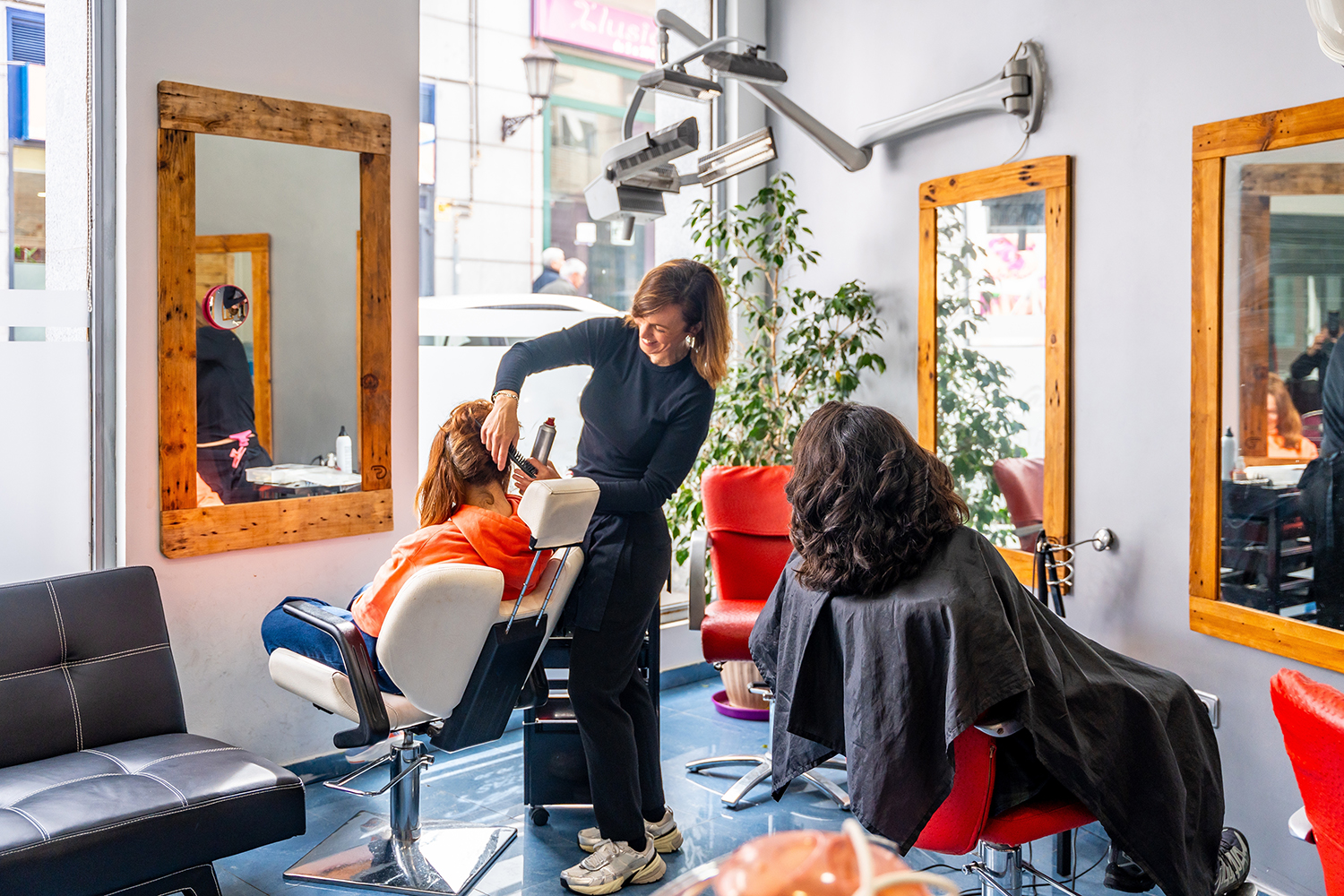 Luxurious Duluth beauty salon studio franchise with illuminated
  mirrors, black chairs, and modern styling stations.